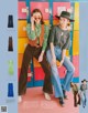 A couple of women standing next to each other in front of lockers.