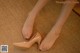 A close up of a woman's feet wearing high heels.