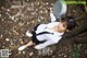 A woman in a school uniform holding a frying pan.