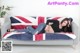 A woman laying on a couch with a union jack blanket.