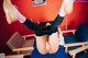 A woman laying on a blue chair with her legs up in the air.