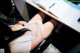 A woman laying on a desk with her legs crossed.